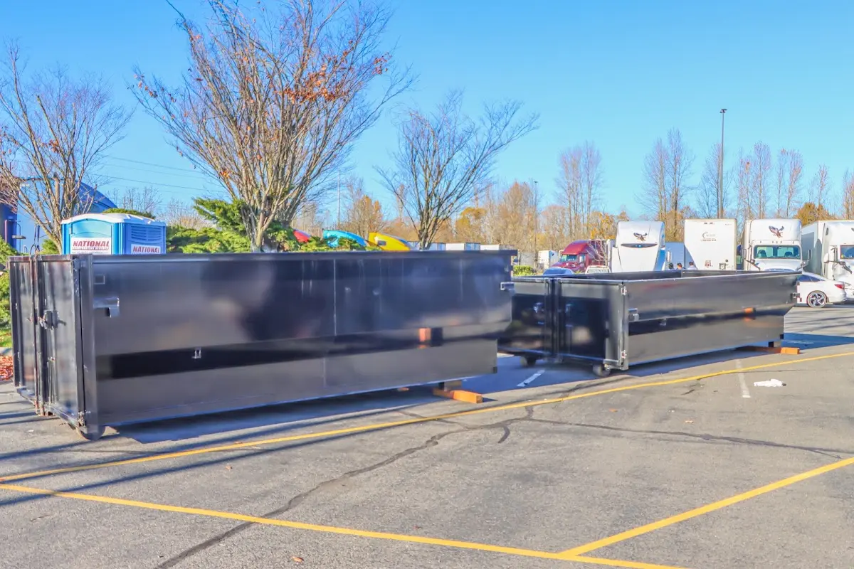 Professional dumpster rental service with roll-off container on residential driveway in Lower Southampton